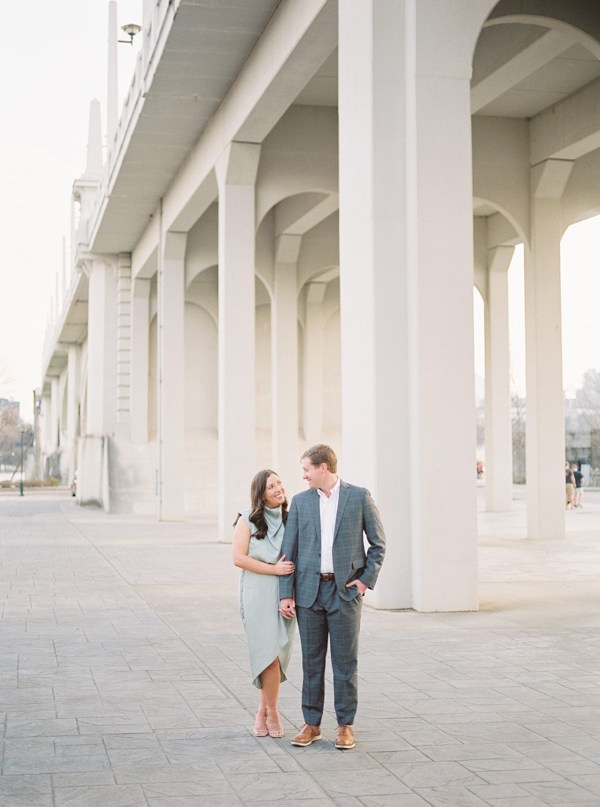 A couple stands under the Market Street bridge in Chattanooga, Tennessee for their engagement session