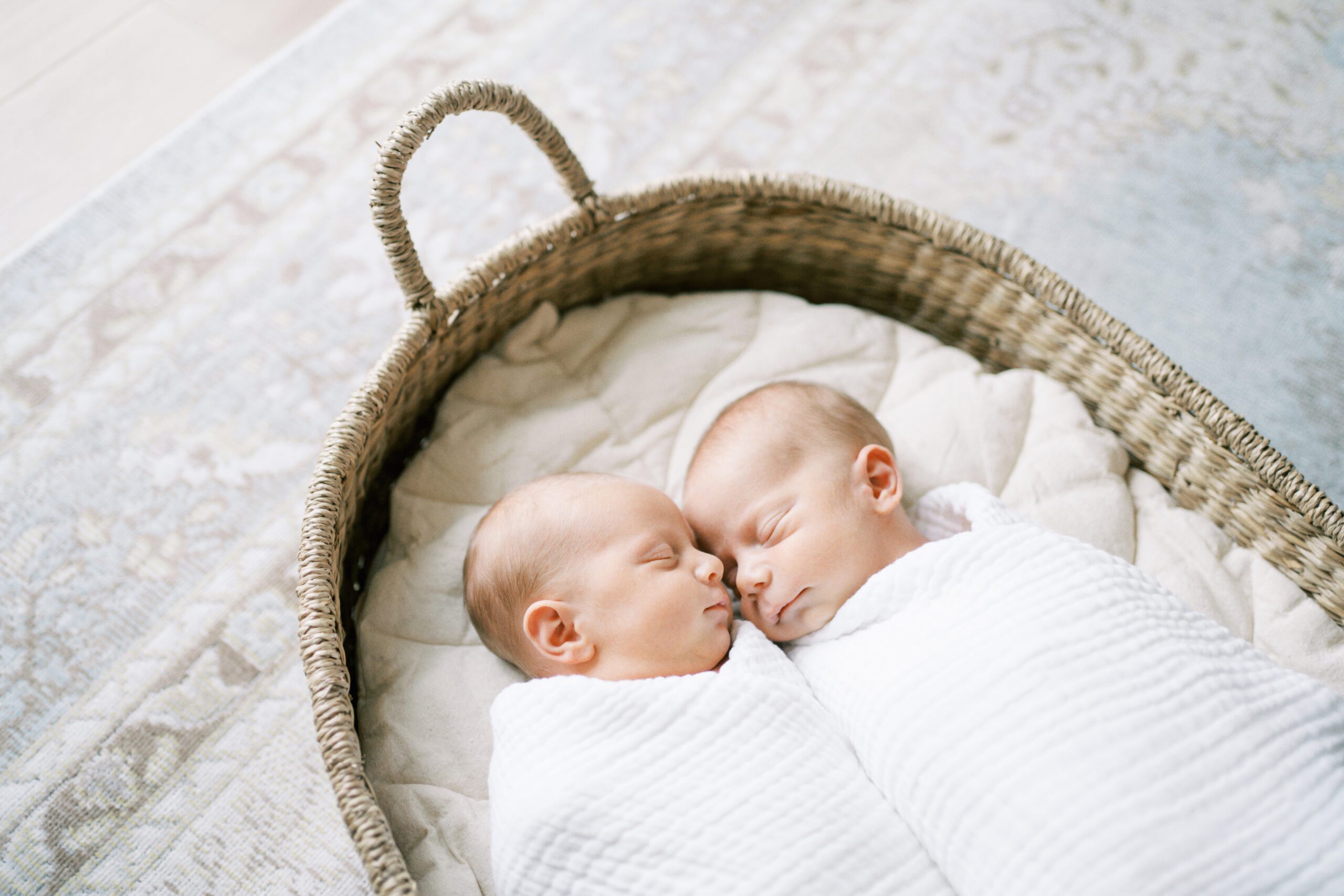 newborn twins snuggle together