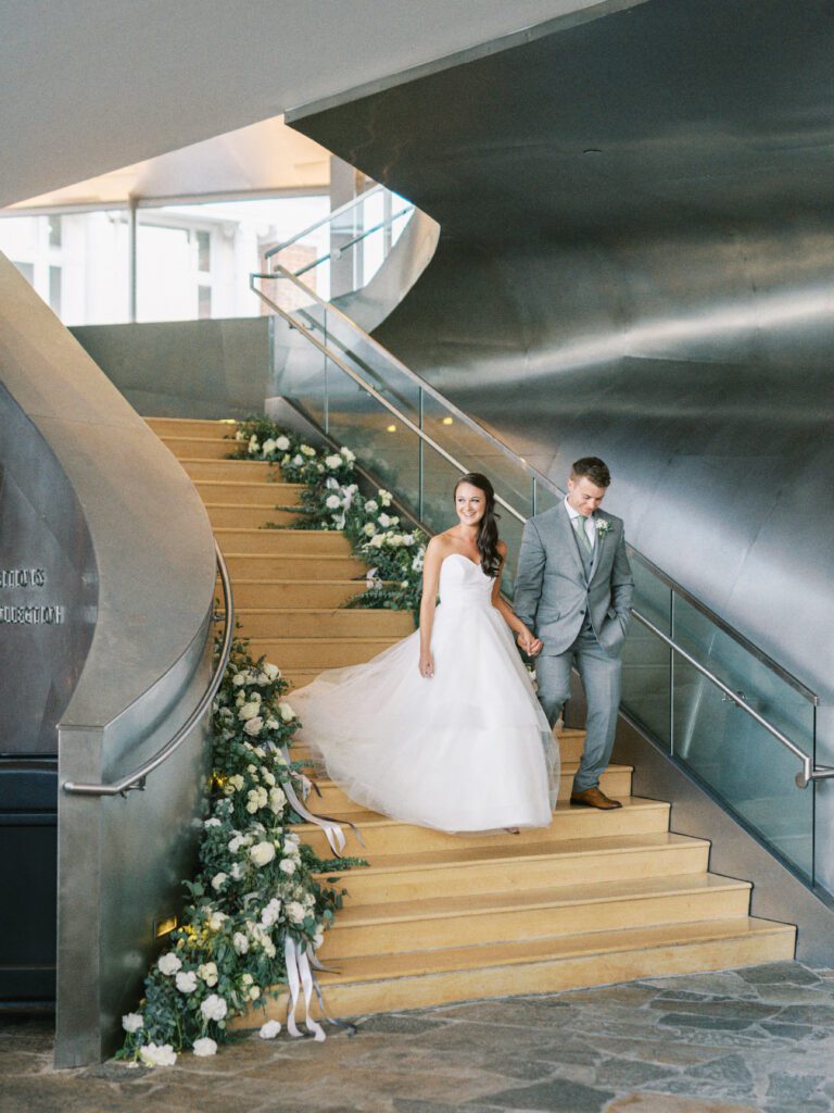 Bride and groom walk down the steps at the Hunter Museum of American Art, a Chattanooga wedding venue, by Kelsey Dawn Photography