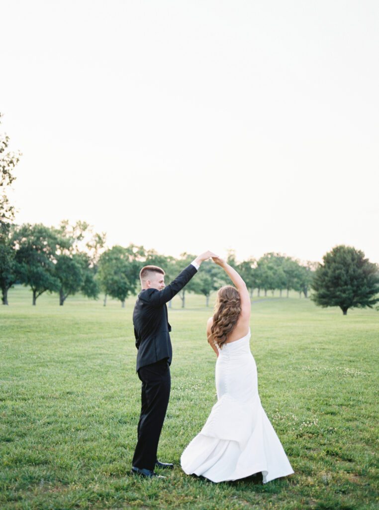 Bride and groom dance outside near the orchard at Blackberry Ridge, a Chattanooga wedding venue, by Kelsey Dawn Photography