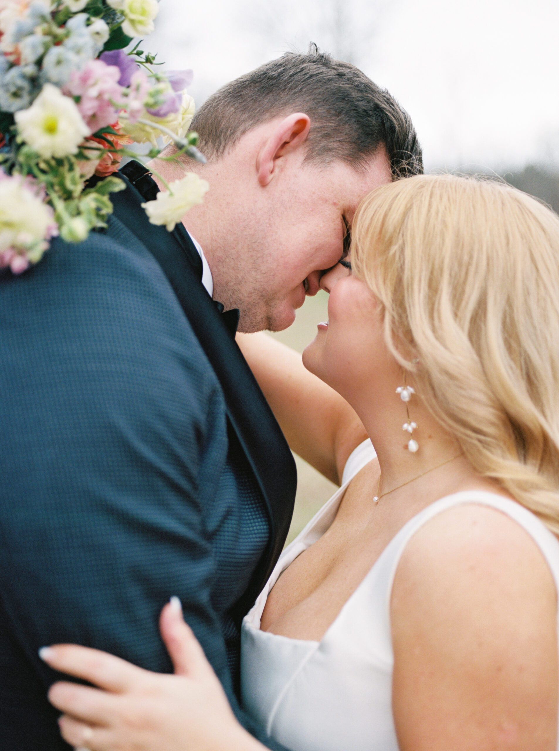 An intimate kiss between bride and groom on film by Birmingham wedding photographer Kelsey Dawn Photography